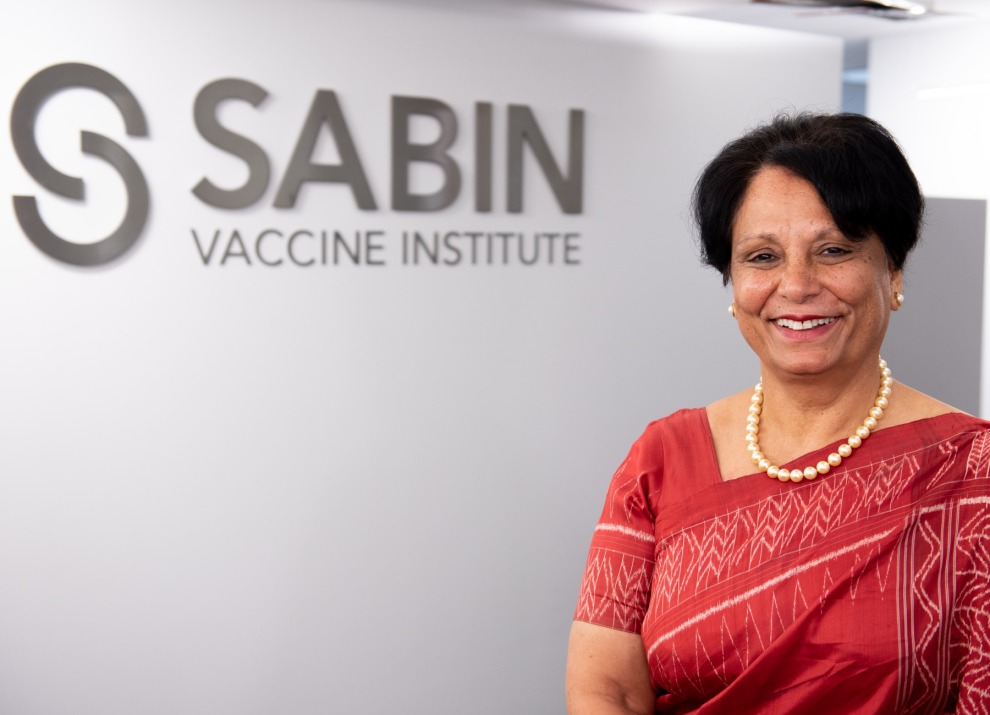 Anuradha Gupta in front of the Sabin Vaccine Institute Sign