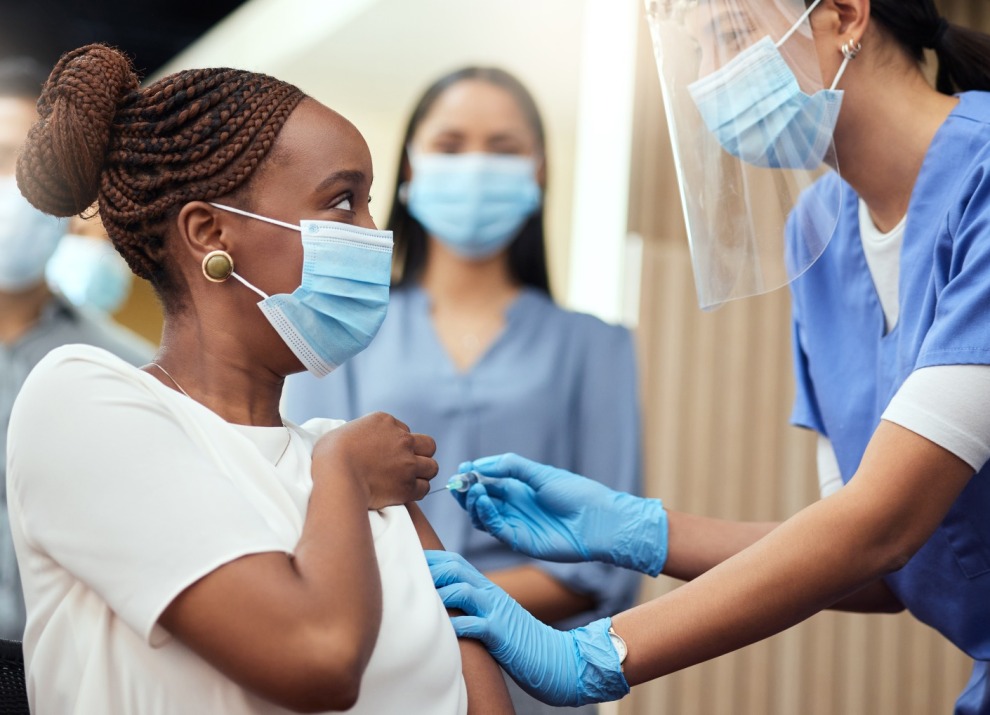 health-worker-gives-vaccine-in-ppe