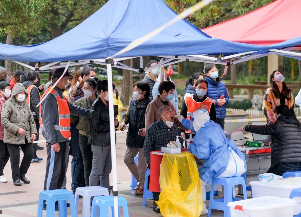 Vaccine outreach underneath tents in a open paved area.