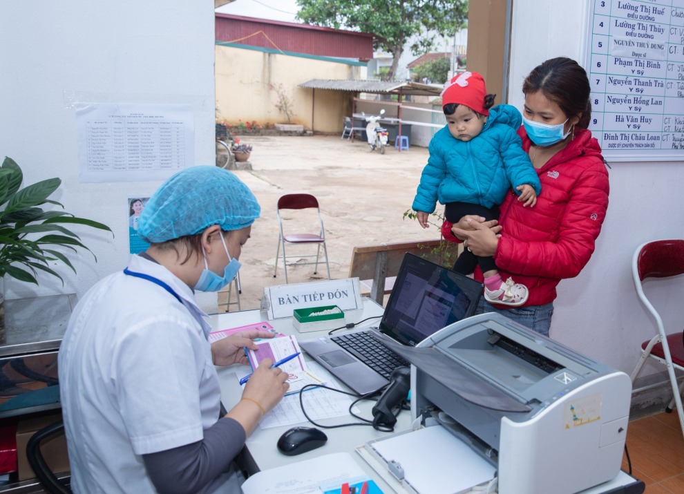 Health worker with mother and child